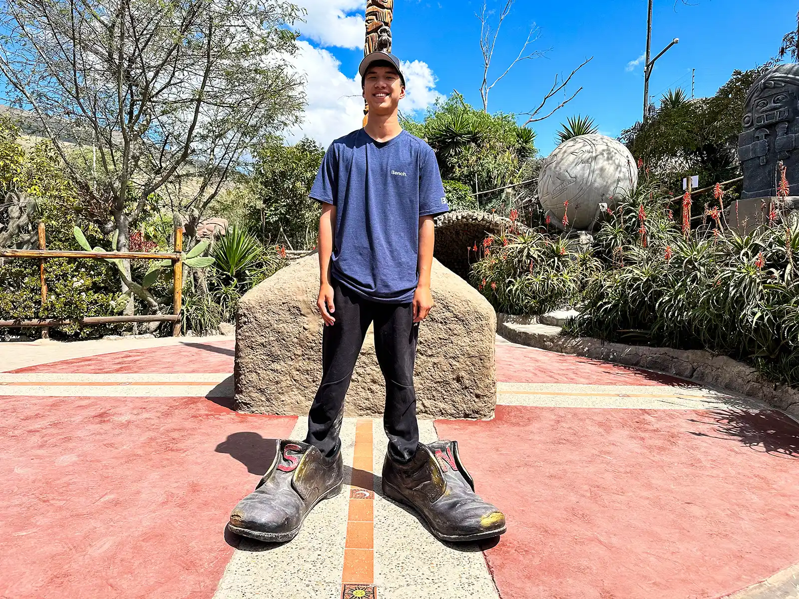 A teenager straddles the equator at the Itinan Museum in Quito