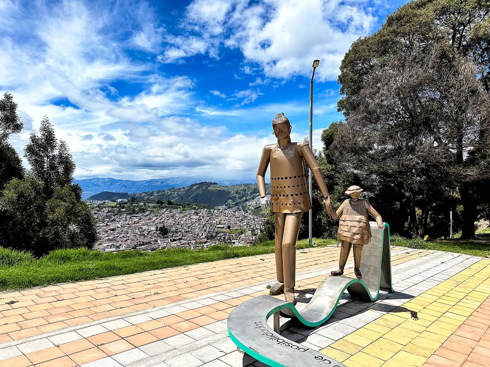 metal sculpture of a mother and son at a Quito viewpoint