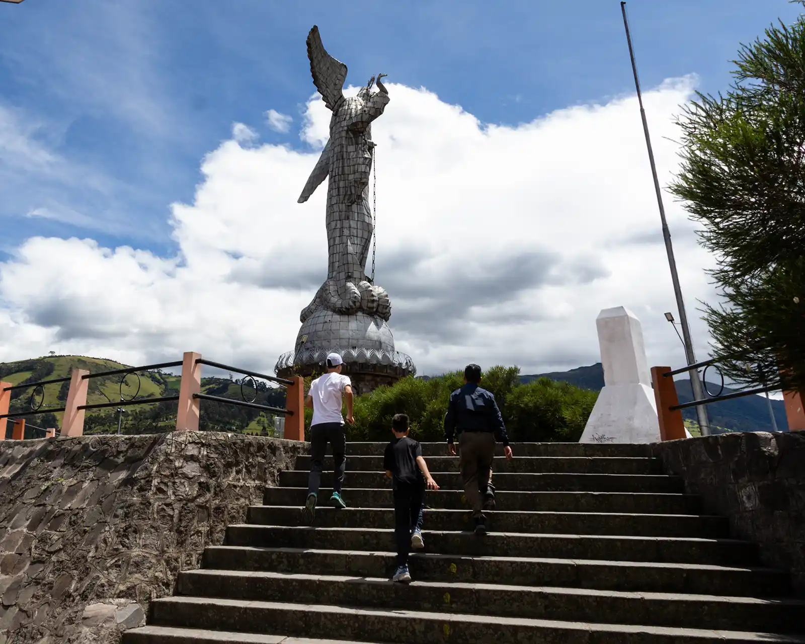Family walking up stairs toward the Virgin of the Panecillo