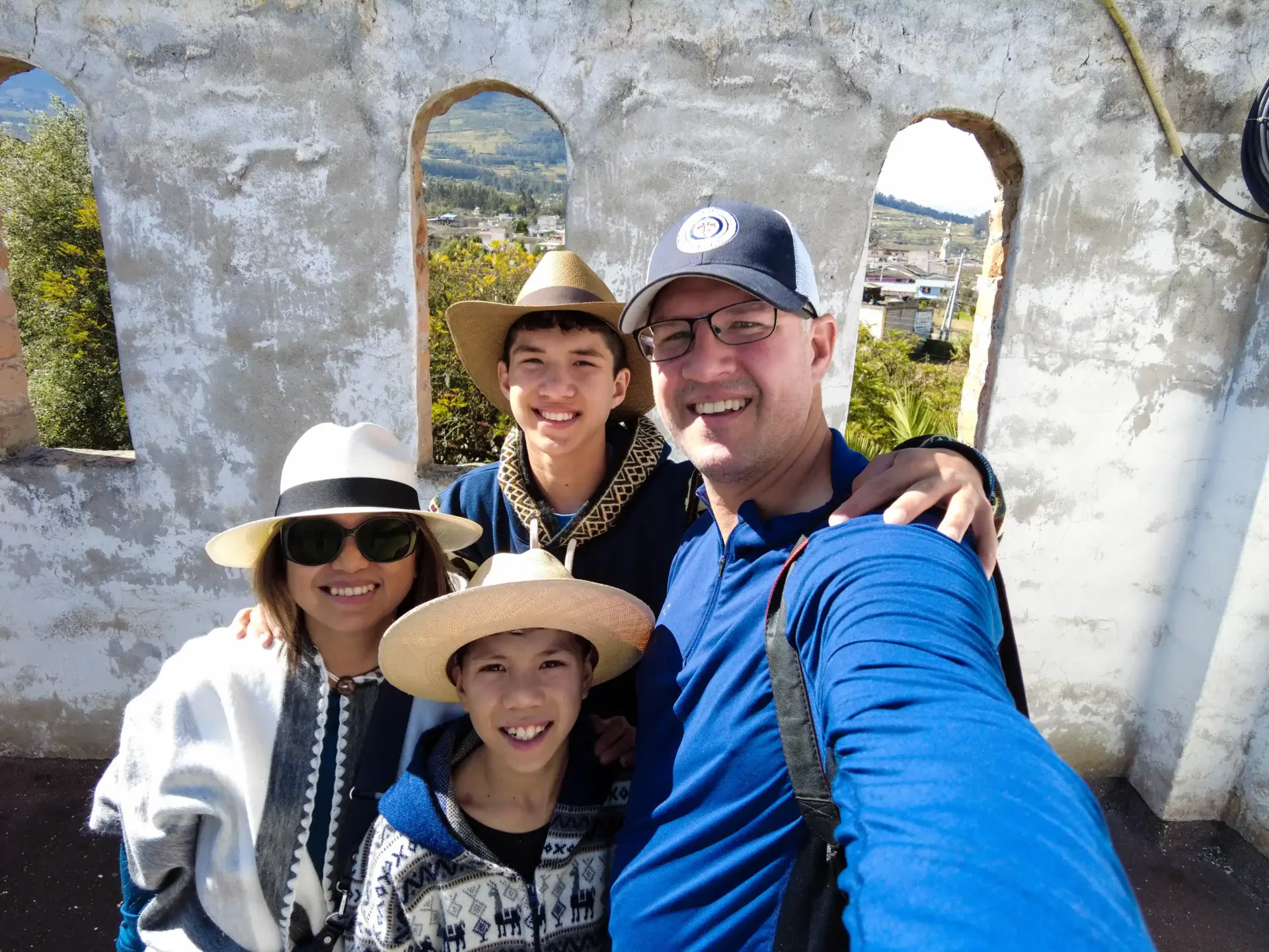 /A family poses for a photo in a historic belltower at the Hacienda Cusin hotel