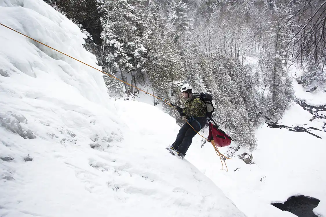 A teenager rappels down an ice wall in Mont Saint-Anne Quebec