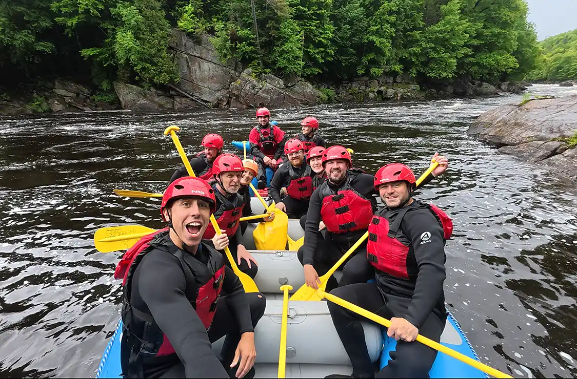 A group of adventurers take a selfie on a white water rafting expedition near Quebec City