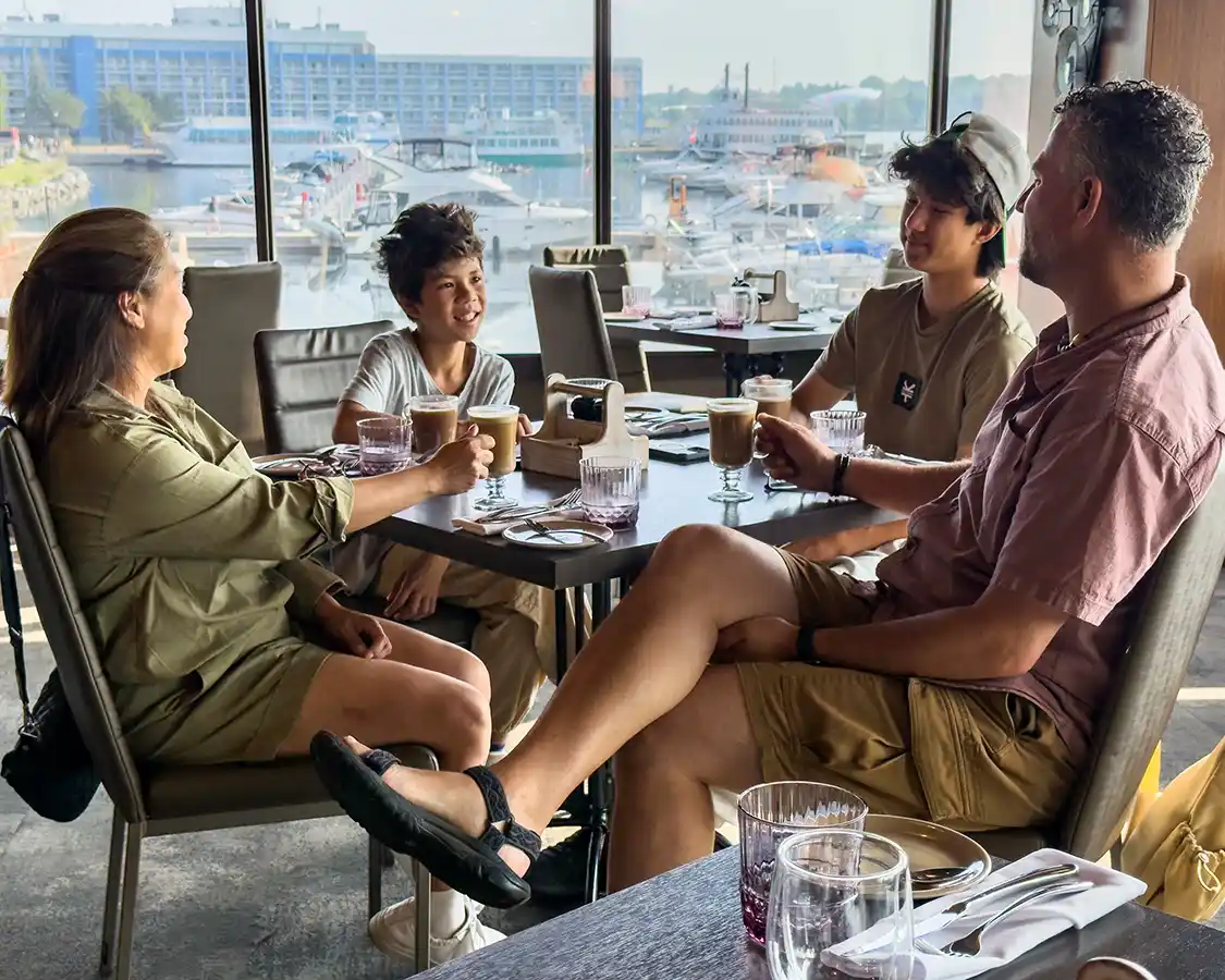 A family enjoys waterfront views during breakfast at Aquaterra Kingston