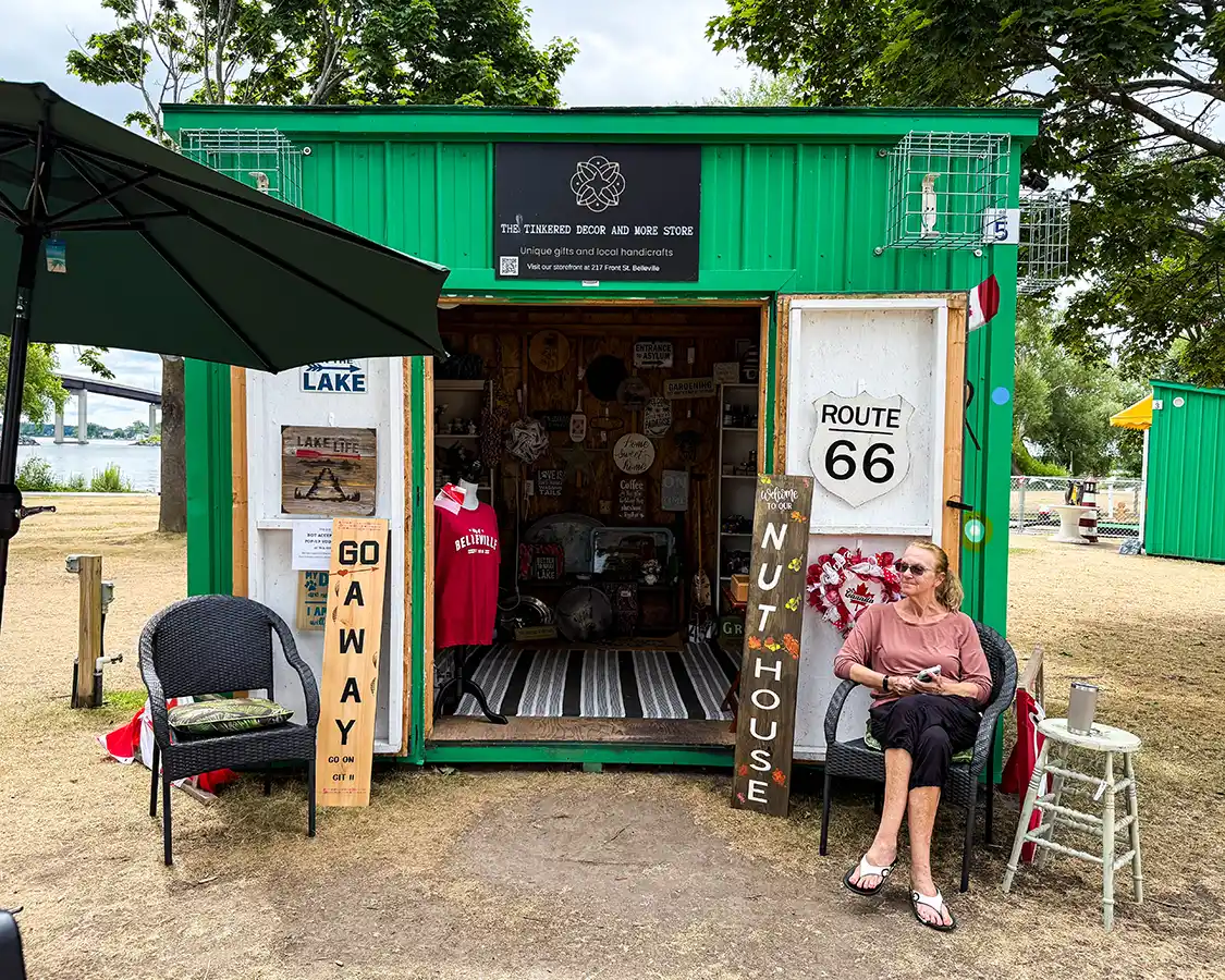 A woman sells crafts at a Bay of Quinte pop up village