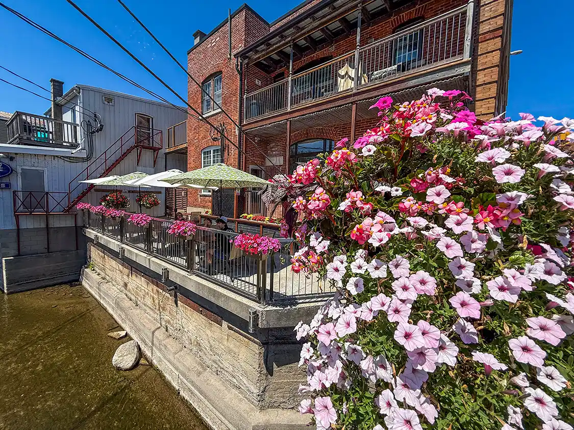 Creekside patio lined with flowers at the Old Bank Cafe in Frankford, Ontario