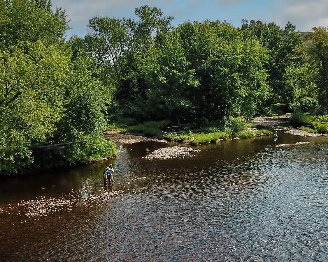 Aerial shot of a family fly-fishing on the La Diable River in Mont Tremblant, Quebec