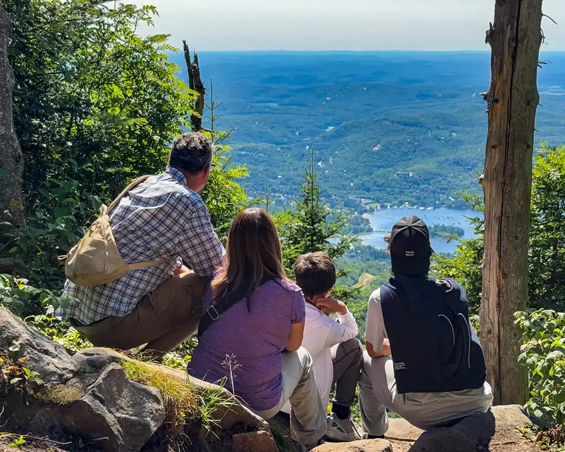 A family takes in the views from atop Mont Tremblant on a hike through the mountain