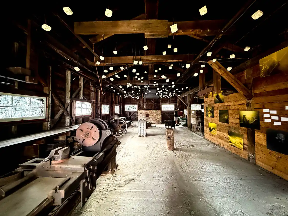 A family walks through an historic forge building at Opemican National Park in Quebec