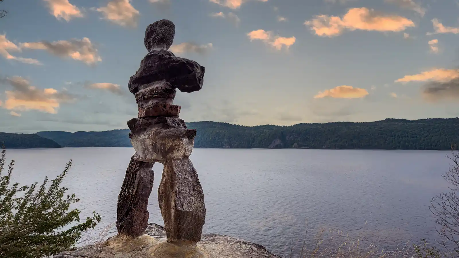 An inukshuk stands on a rock overlooking Lake Temiskaming in Parc National d'Opemican