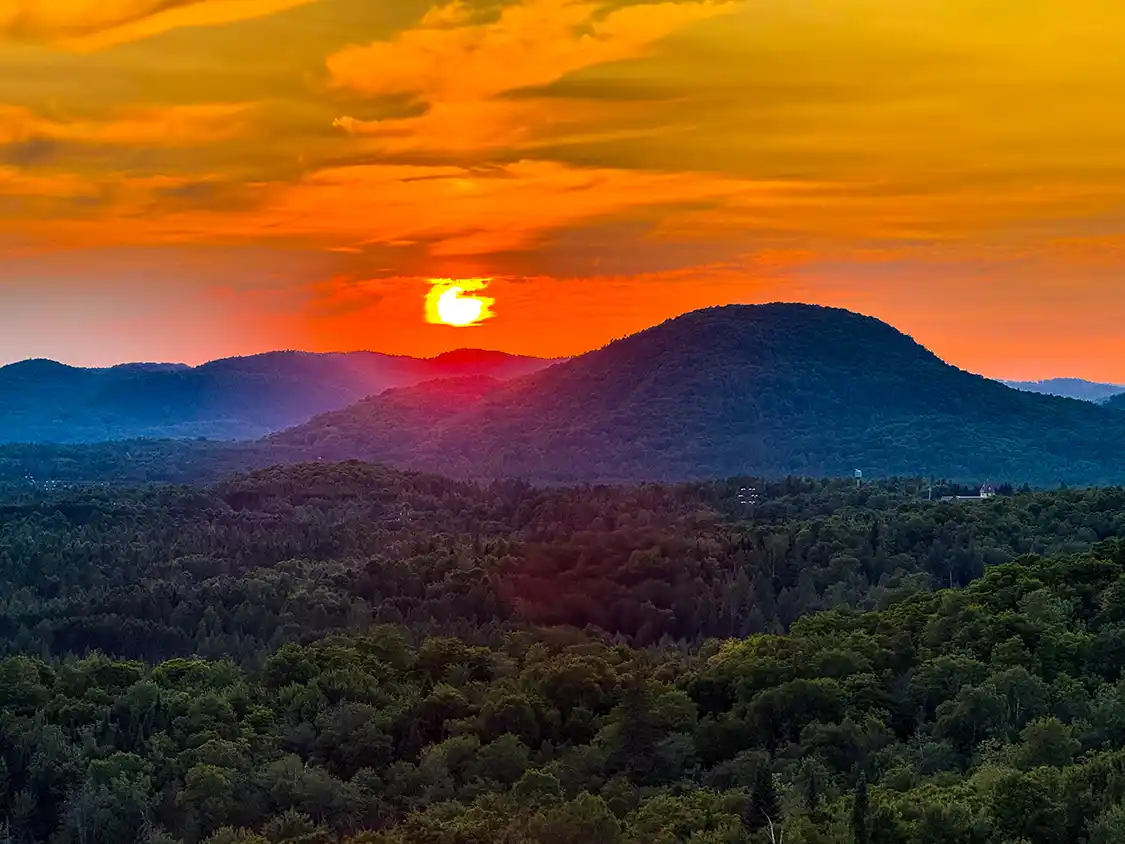 Sunset over the tree-covered Laurentian mountains in Mont-Tremblant, Quebec