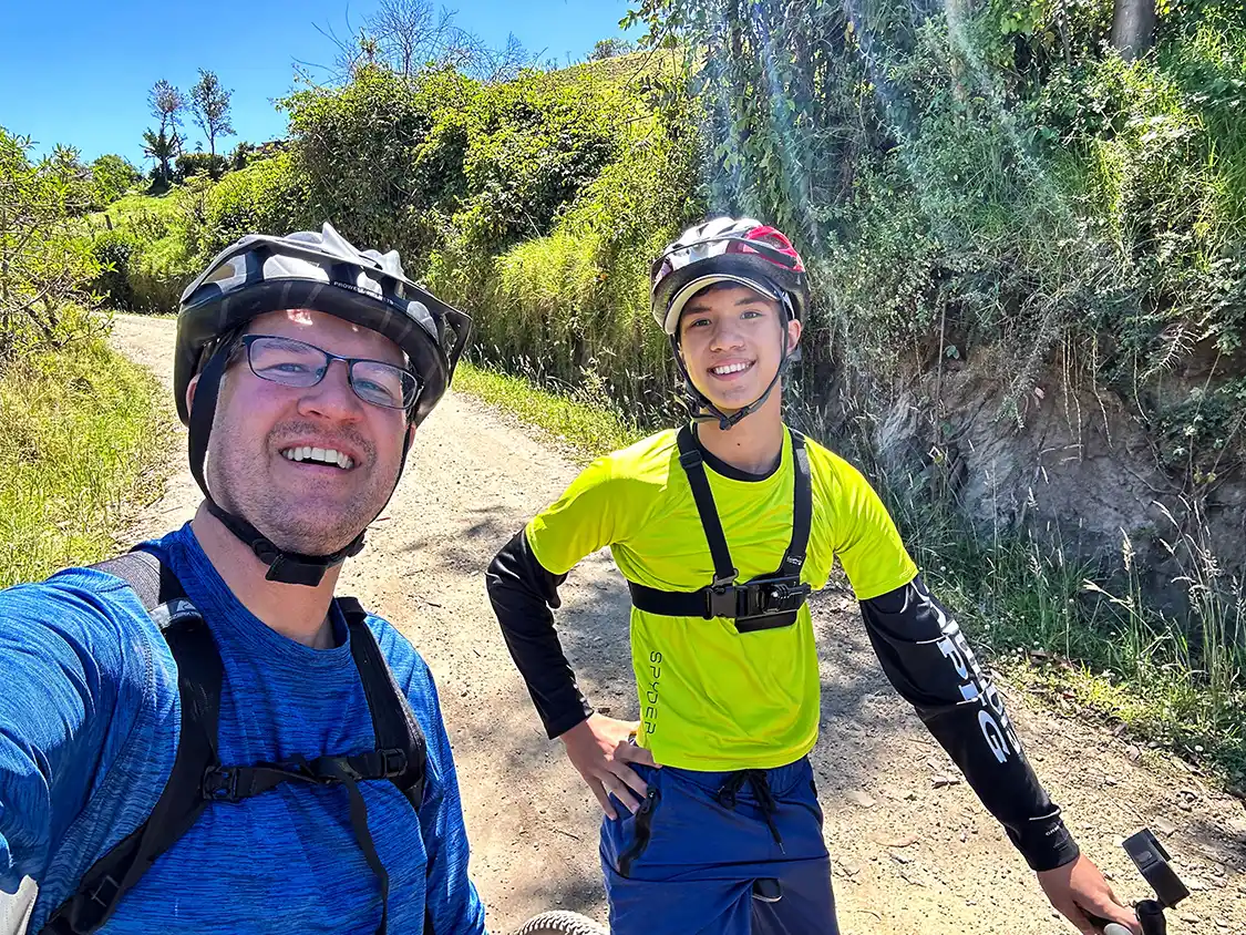father and son pose for a photo while mountain biking in Quilotoa, Ecuador