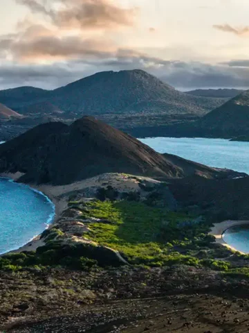 One of the Galapagos Islands splits the Pacific Ocean at sunset