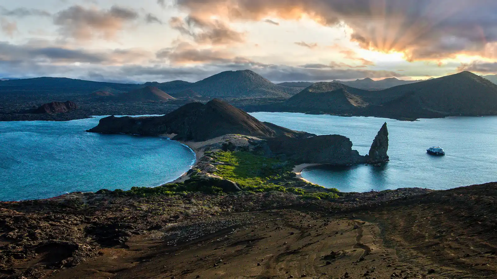 One of the Galapagos Islands splits the Pacific Ocean at sunset