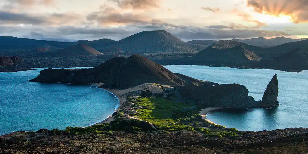 One of the Galapagos Islands splits the Pacific Ocean at sunset
