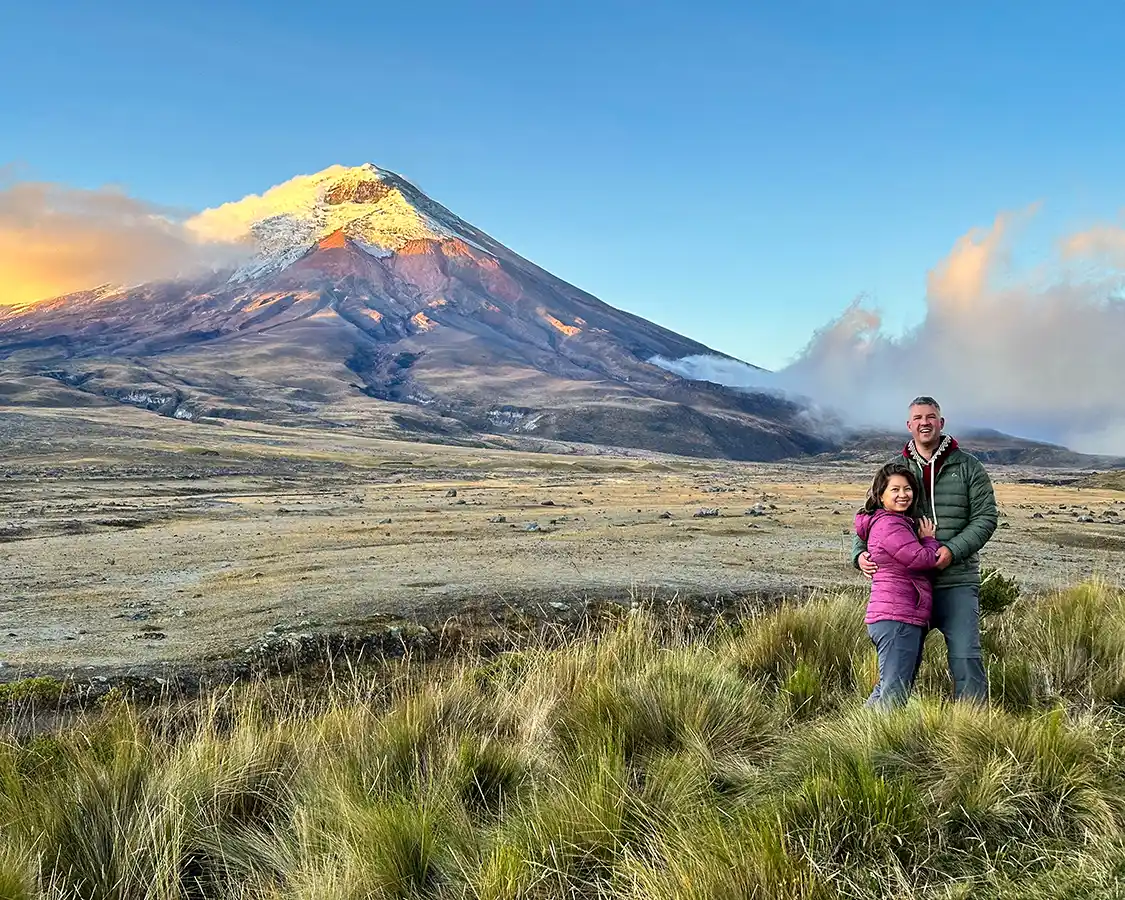 A man and woman embrace beneath Cotopaxi Volcano