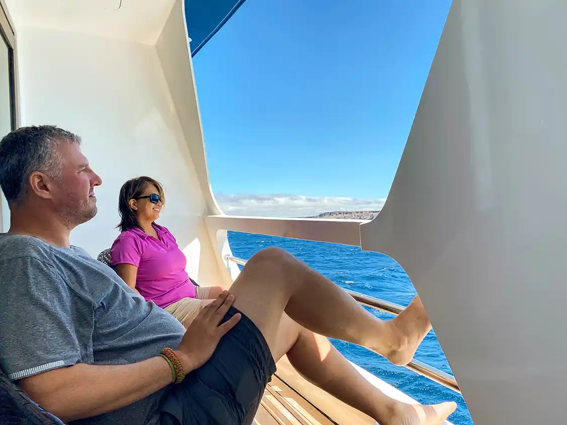 Kevin and Christina Wagar relax ona Galapagos Cruise ship balcony