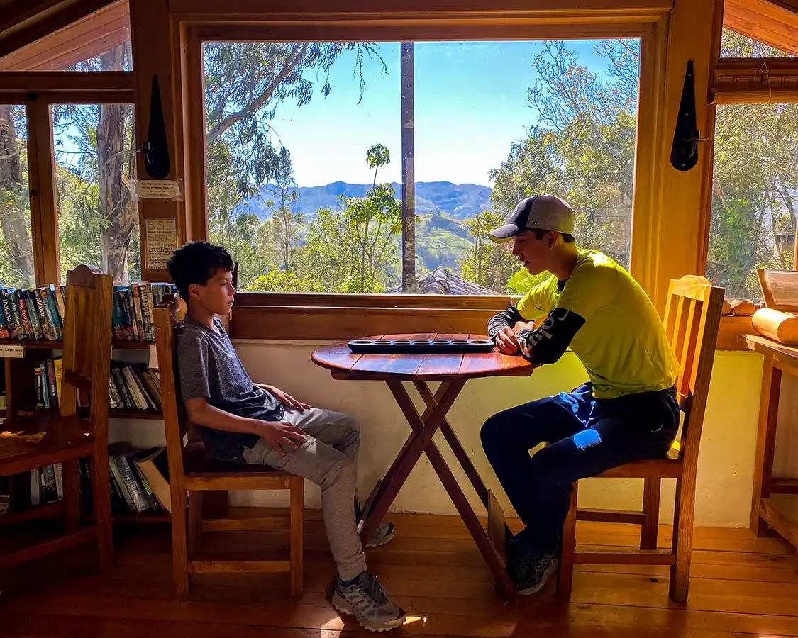 Two boys play a board game at the Black Sheep Inn