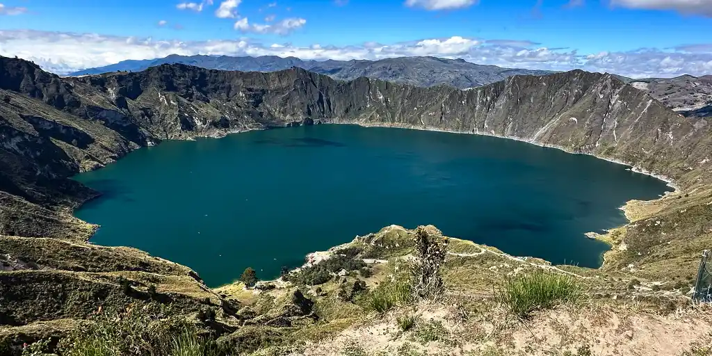 The beautiful Quilotoa Ecuador volcanic crater with turquoise water surrounded by steep cliffs
