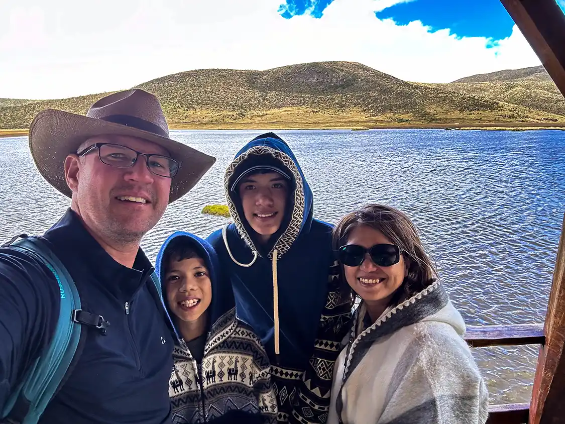 Wandering Wagars family smiles for a photo in front of Limpiopungo Lagoon