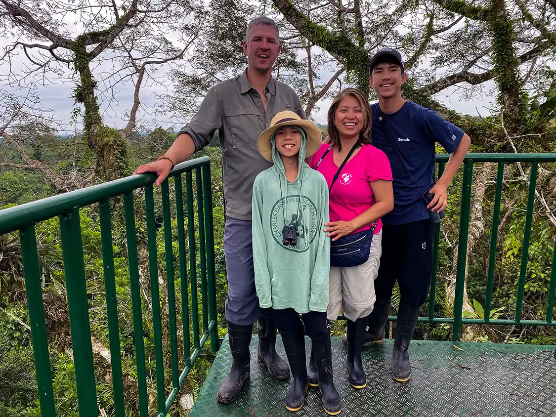 A family poses on top of an observation tower at La Selva Lodge Amazon Rainforest