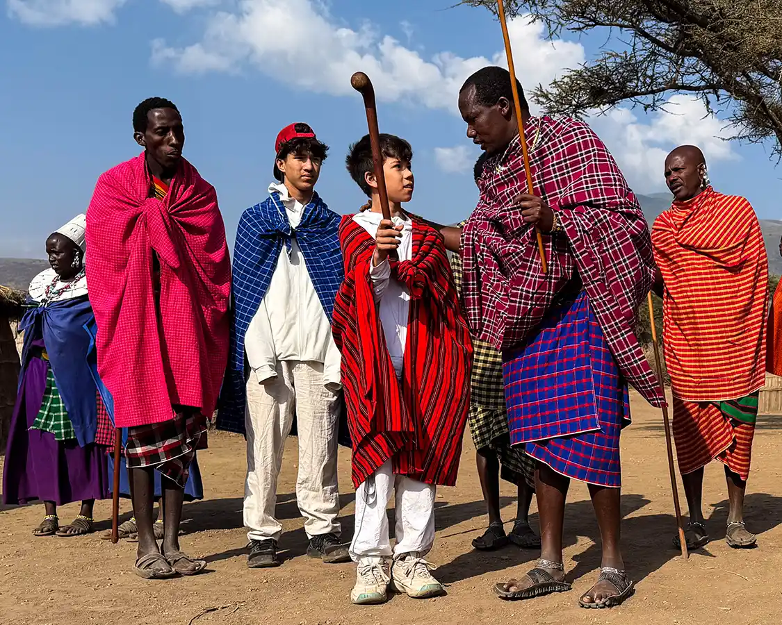 A Maasai Tribesman speaks with a young boy