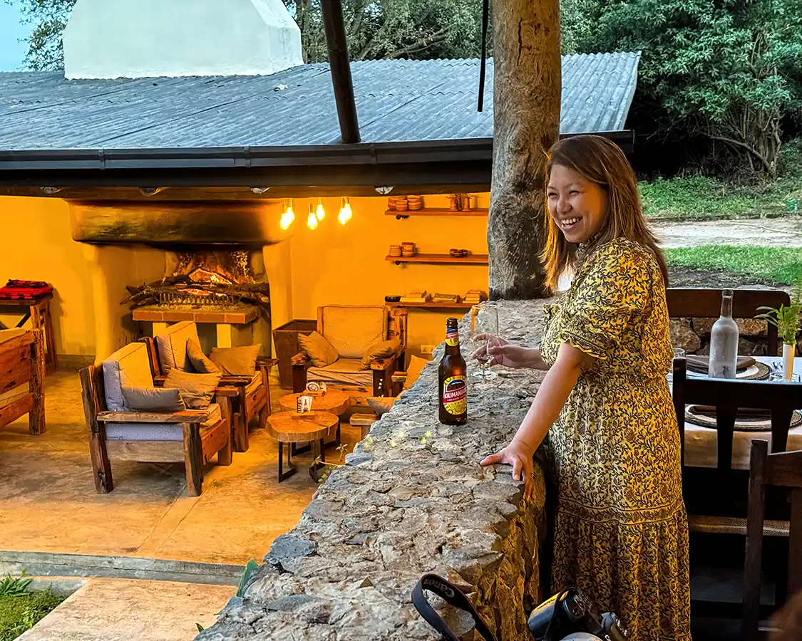 A woman drinks a beer at Karuma Coffee Plantation Lodge in Arusha Town Tanzania