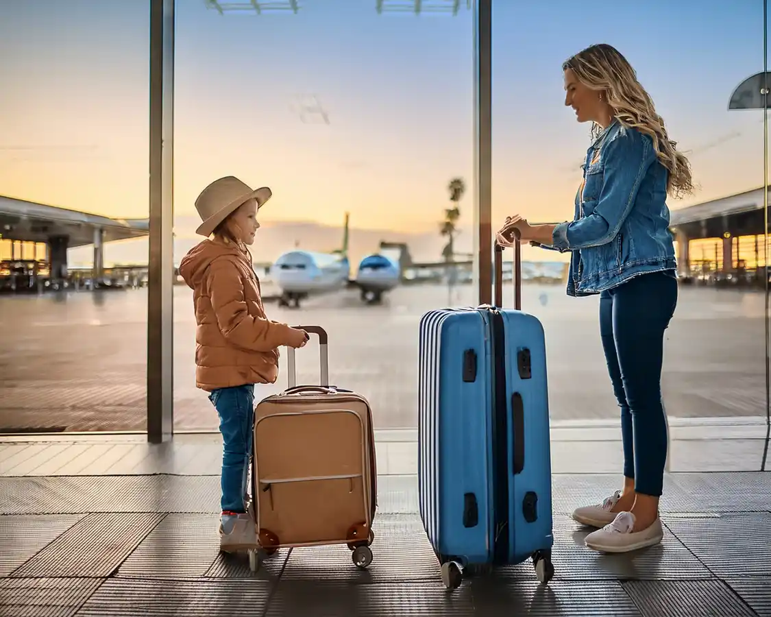 Mother and daughter choosing between check in and carry on luggage for a TSA check
