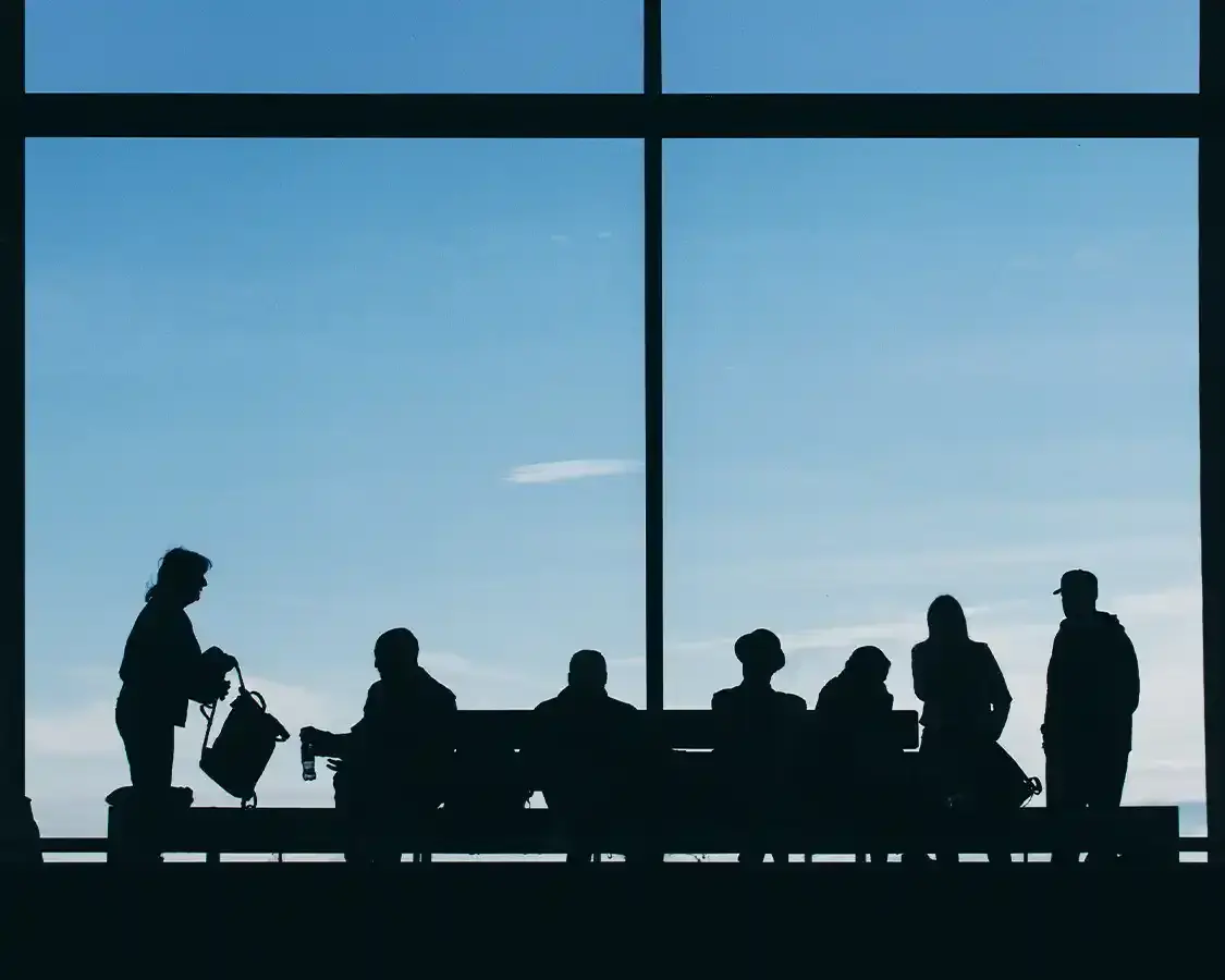 People in front of a window at an airport