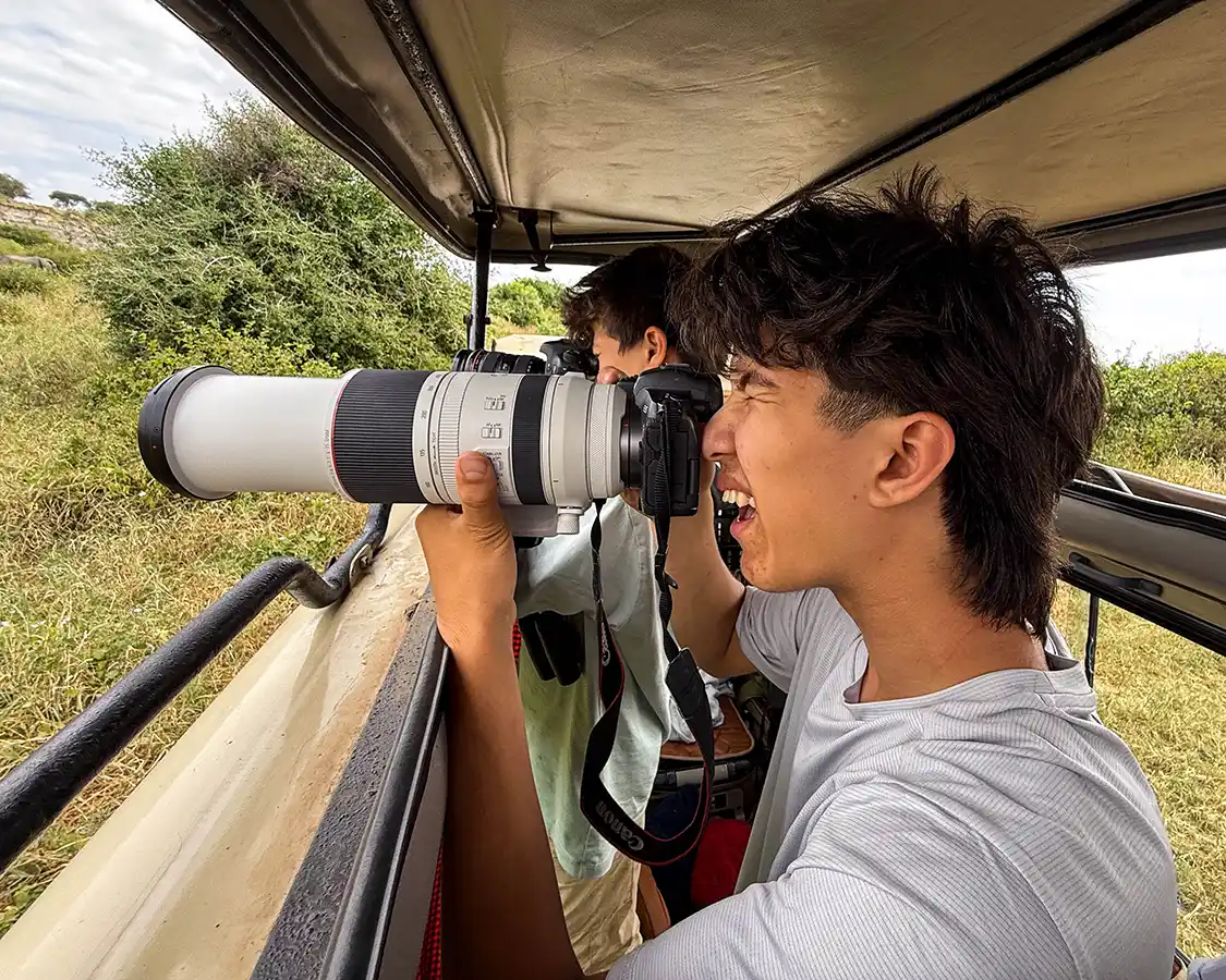 Two boys photographing wildlife in Tarangire National Park