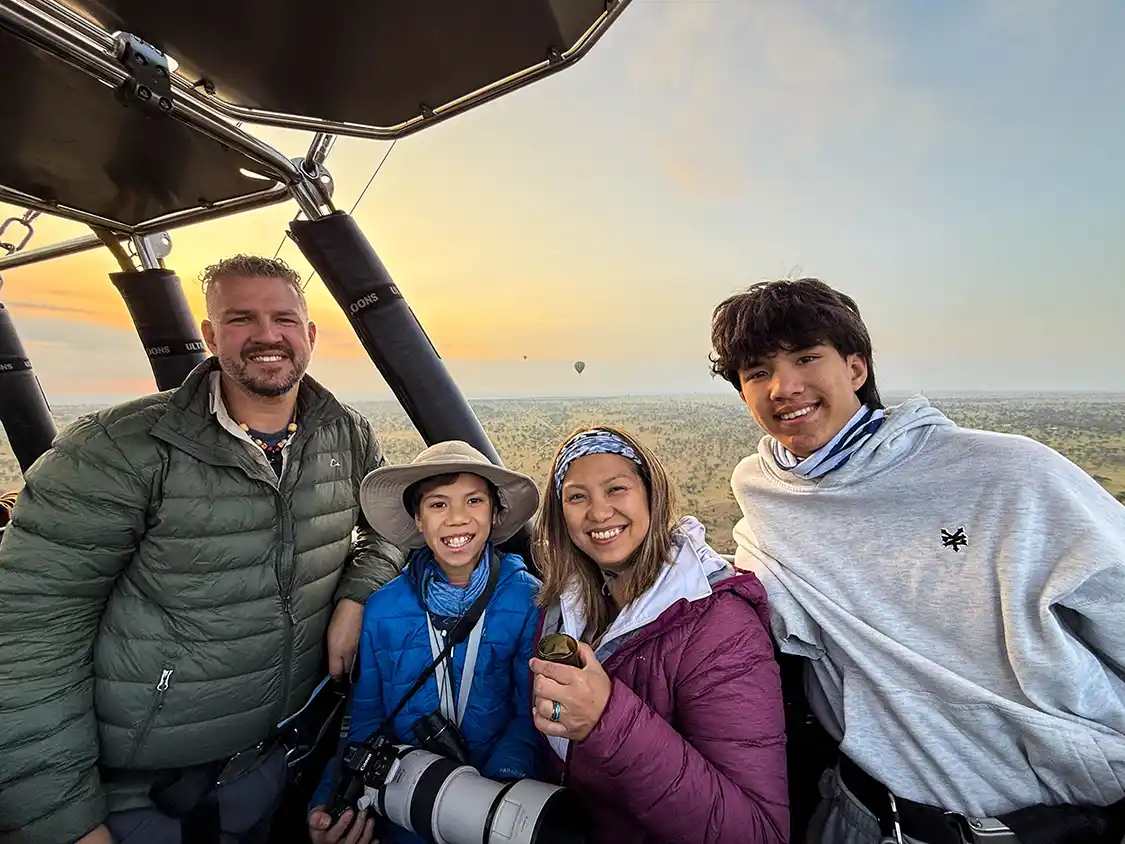 Wandering Wagars family smile for the camera on a hot air balloon in Serengeti National Park Tanzania