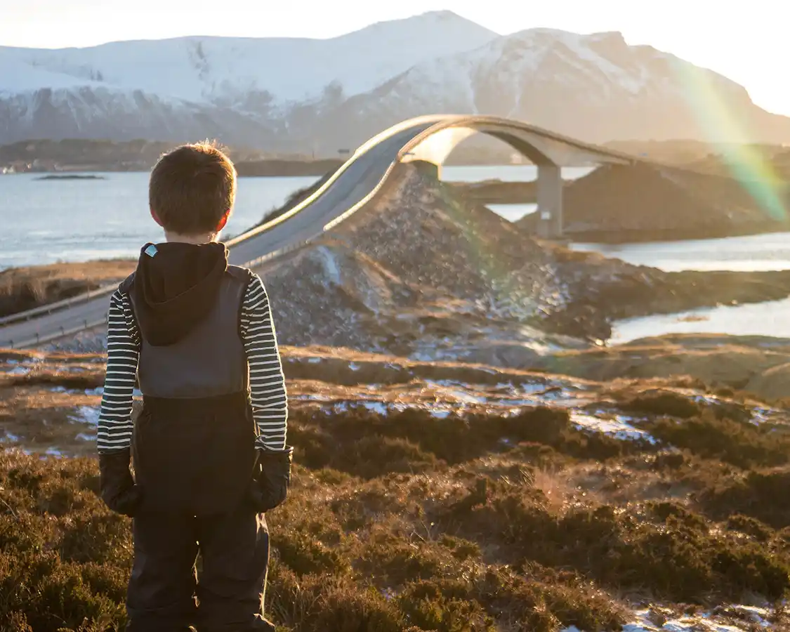 Boy looks out at the Great Ocean Road in Norway