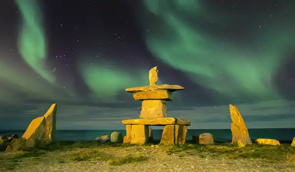 Inukshuk under the northern lights Canada Family Travel