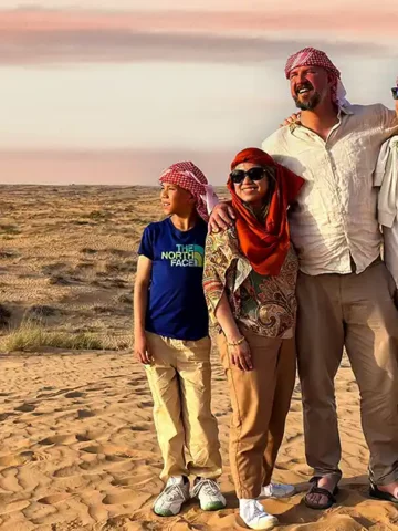 A family smiling on a desert tour happy because they're connected with the best eSIM for travel