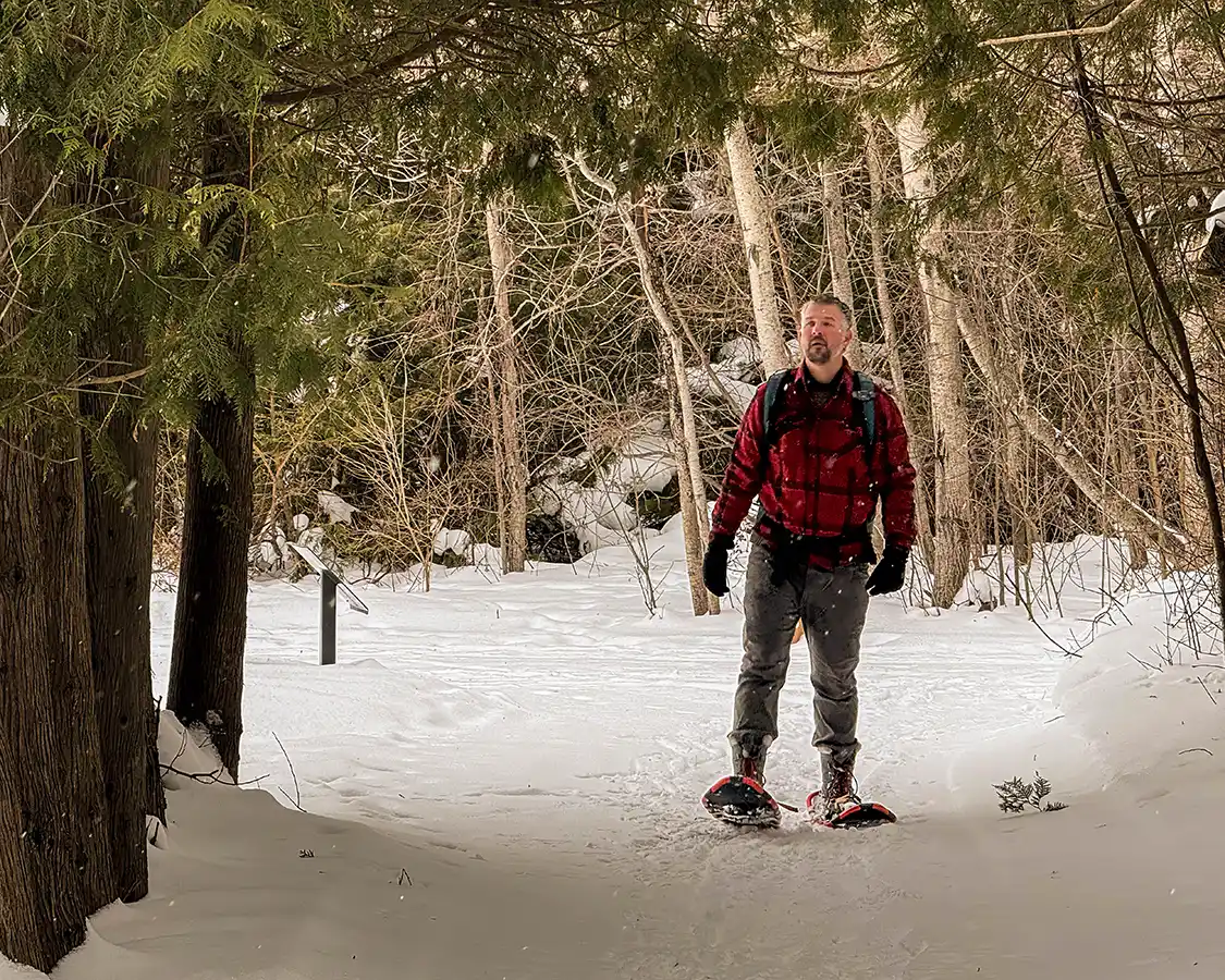 Man snowshoeing through Terra Cotta Conservation area