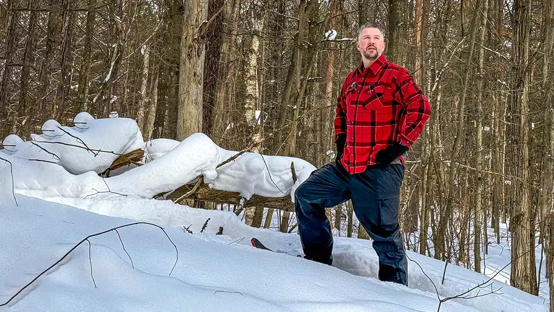 A man in a red coat snowshoeing near Toronto