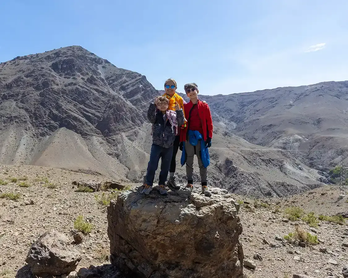 A Mother and her two sons pose for a photo while hiking in the Atlas Mountains in Morocco