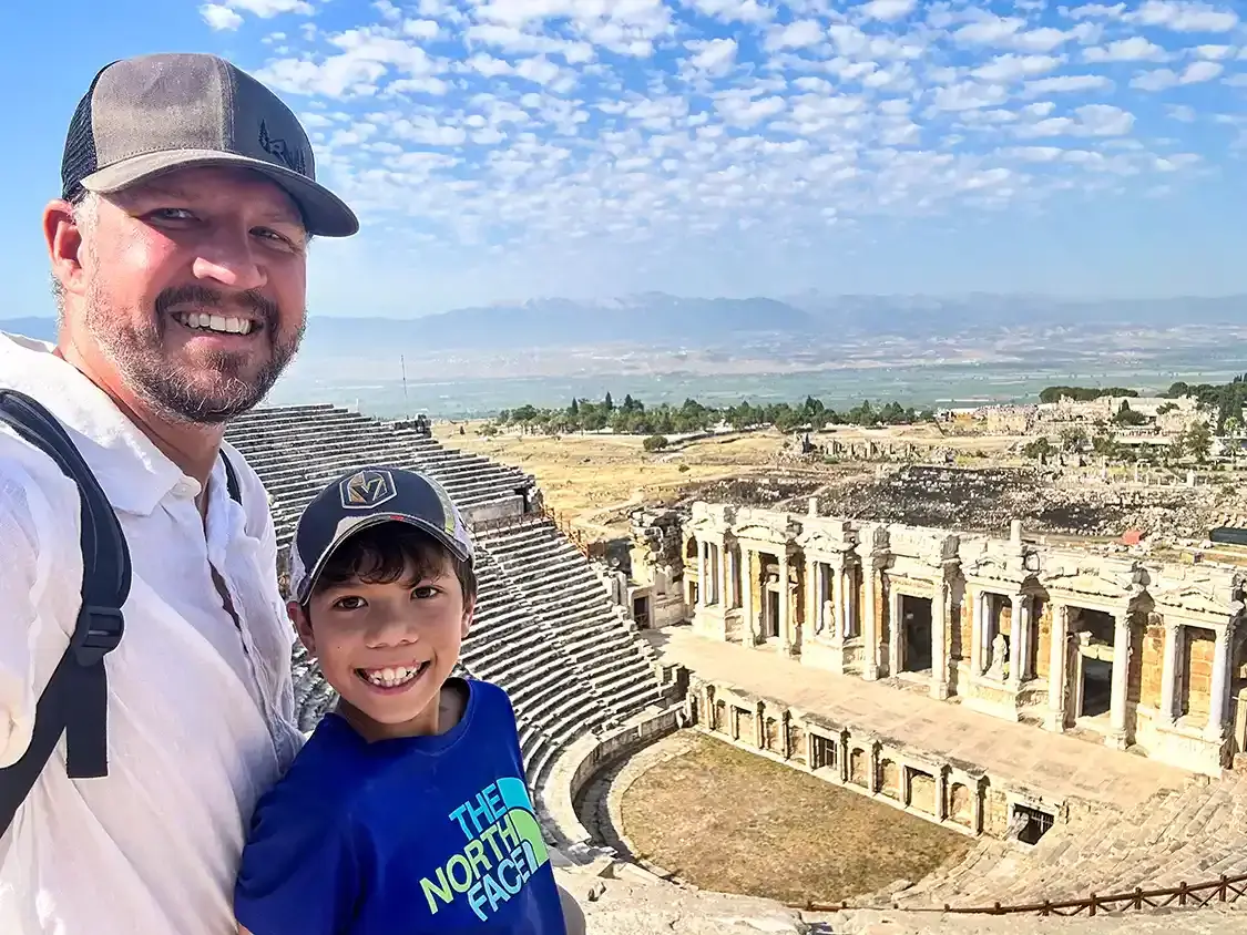 A father and son take a selfie at the theater in Pamukkale Turkey