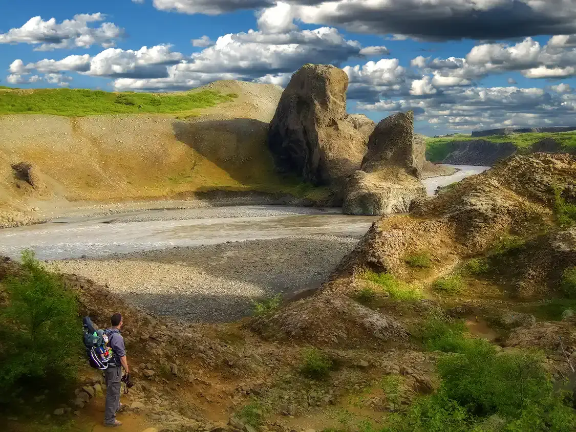 FAther hikes a beautiful valley with his baby near Husavik Iceland