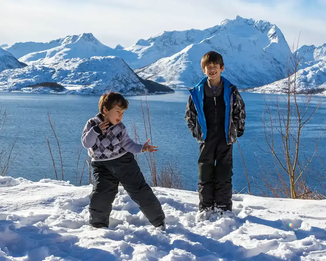 Two boys dance while hiking in the Norwegian mountains