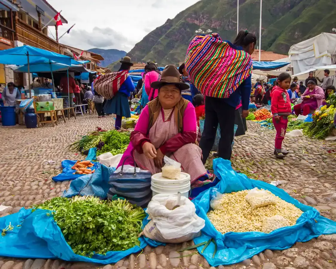 A Quechuan woman selling vegetables at the Pisac Market in the Sacred Valley