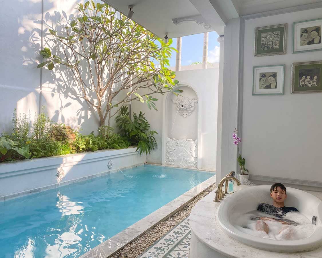 A boy relaxes in a tub at a luxury hotel in Chiang Mai, Thailand