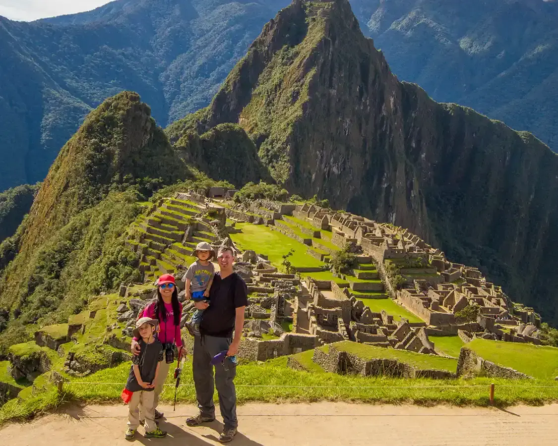 A family with young children explore the ruins of Machu Picchu