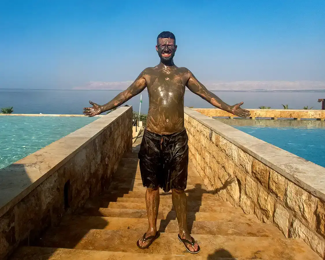 Kevin Wagar covered with mud from the Dead Sea in Jordan