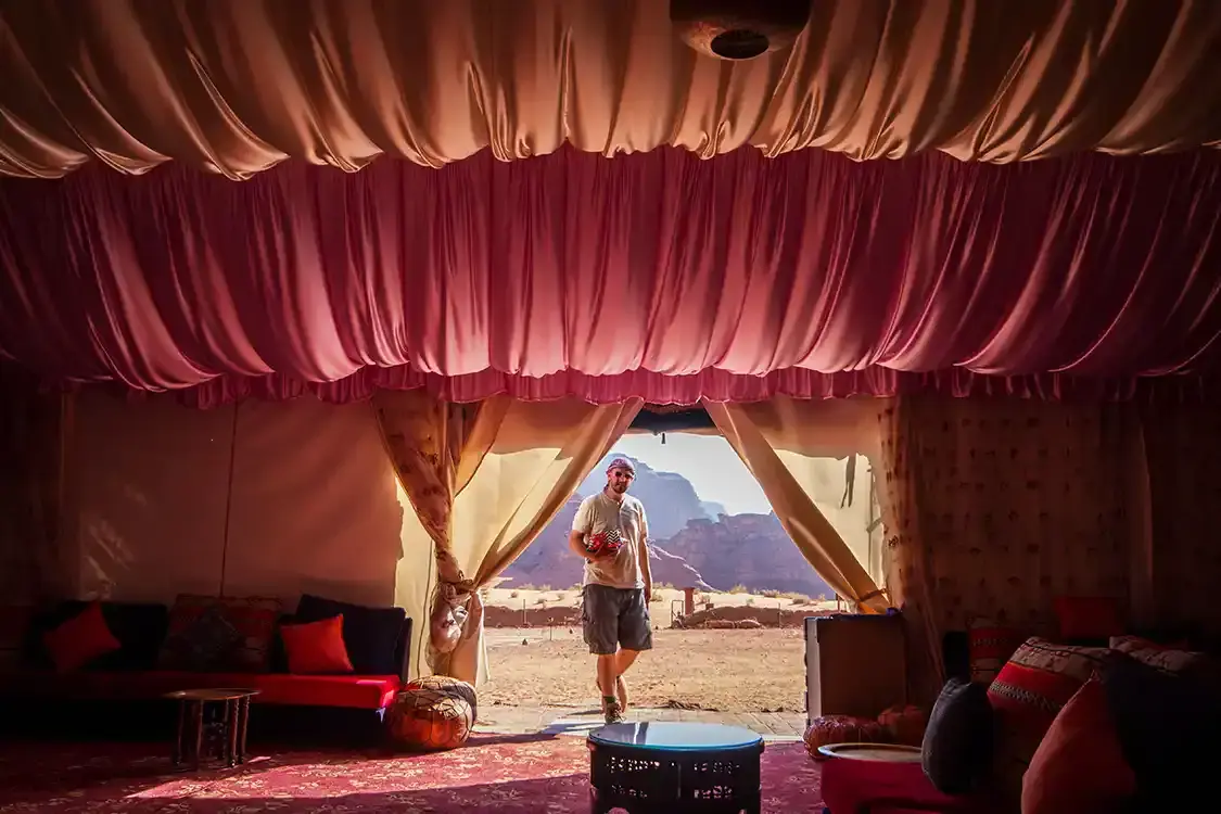 Man walking into a Bedouin tent wearing a keffiyeh