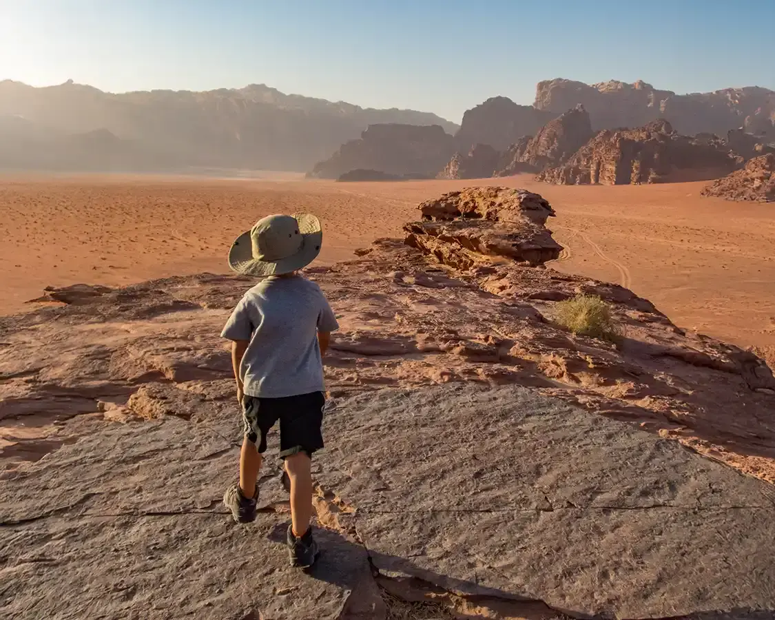 Young boy hiking through the Wadi Rum Desert