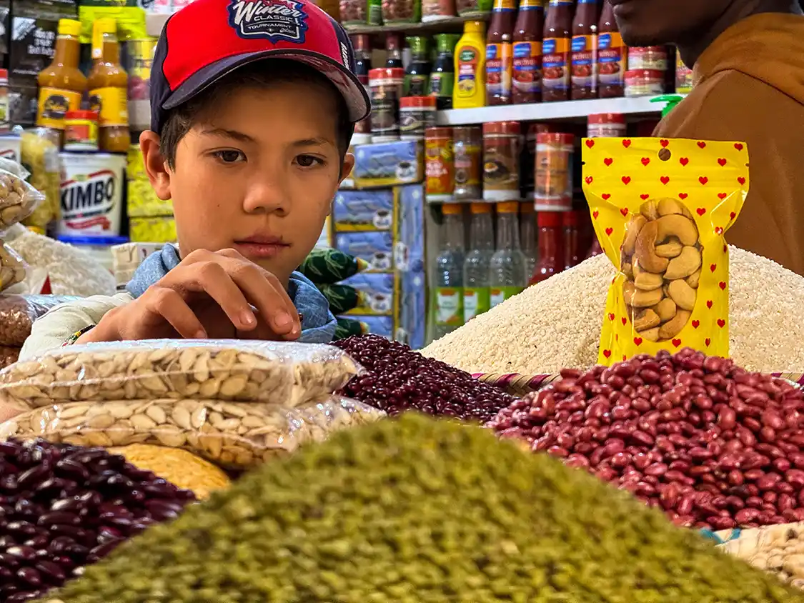 Dylan Wagar picks through spices at the Arusha Central Market