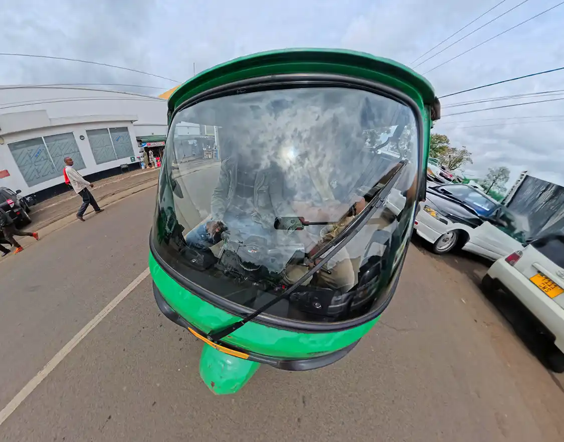 Family riding in a tuk-tuk in Arusha Tanzania