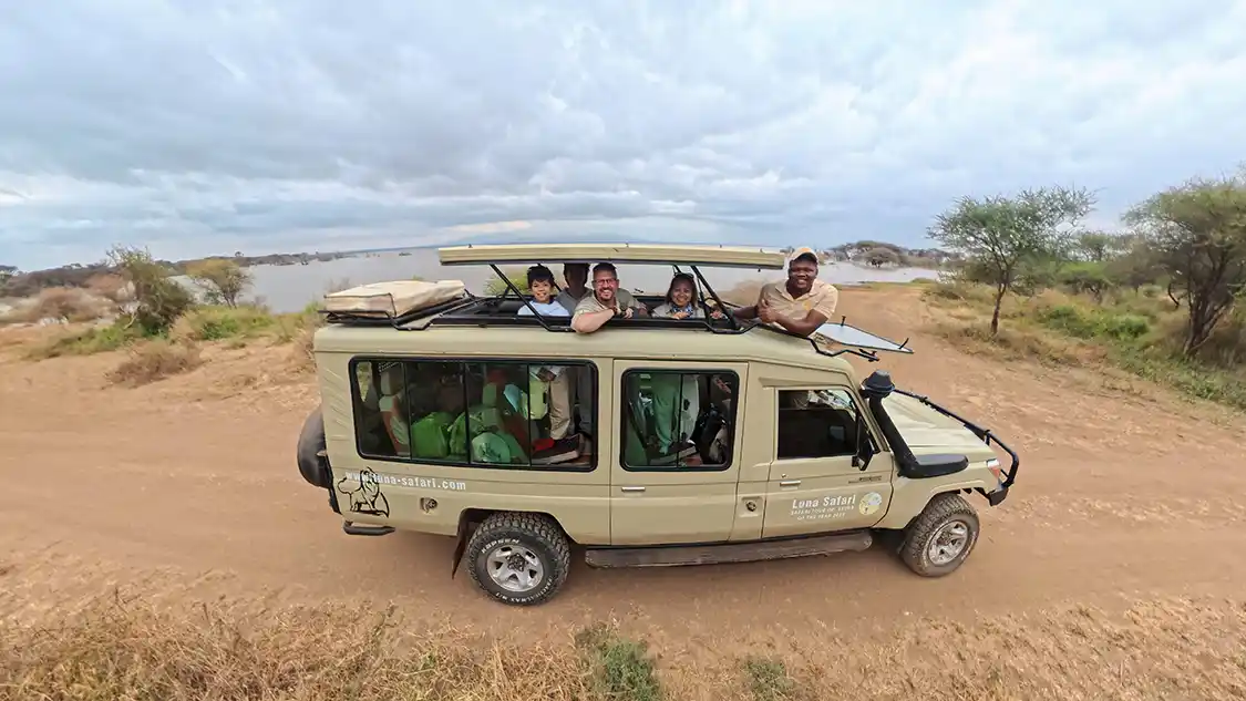 Wandering Wagars family on safari with their guide Omary in Lake Manyara Tanzania