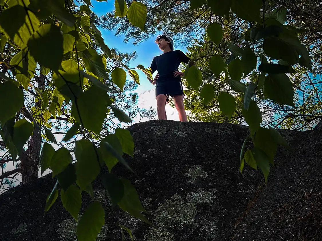 Dylan Wagar finds some massive boulders to climb along the Crowbar Lake Hiking Trails