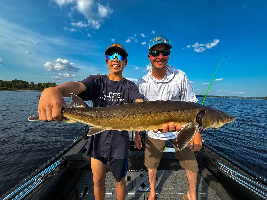 Dylan Wagar shows off his sturgeon from the Saint John River with Fins and Feathers Fishing Outfitting